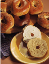 Load image into Gallery viewer, New York Bagel, cut in half and sitting on a small plate.