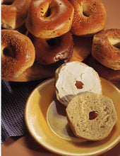 Load image into Gallery viewer, New York Bagel, cut in half and sitting on a small plate.
