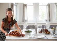 Load image into Gallery viewer, Teenage Girl Decorating a table with Challah Bread. 
